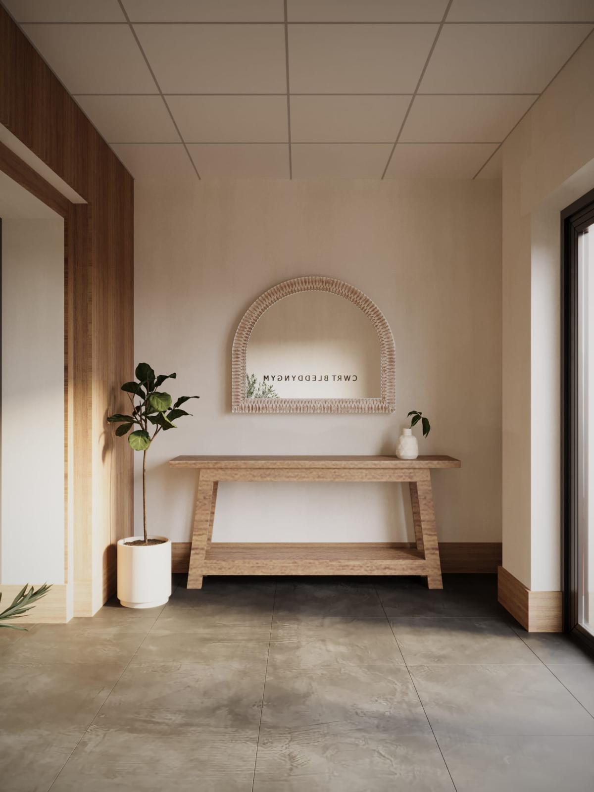 The arched mirror and oak console at the Cwrtium entrance